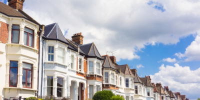 Row of houses and clouds with blue skies at the top