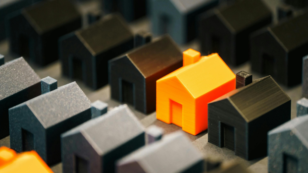 Rows of black houses and orange house