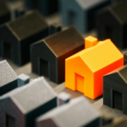 Rows of black houses and orange house