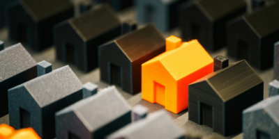 Rows of black houses and orange house