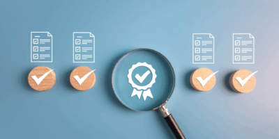 Document outlines with a magnifying glass on a badge with blue background