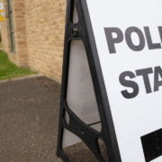 A picture of board stating polling statsion with arrow under