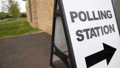 A picture of board stating polling statsion with arrow under