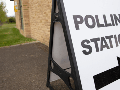 A picture of board stating polling statsion with arrow under