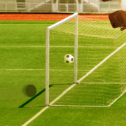 Football pitch with ball in the goal and a camera overlooking this
