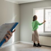 Womanin green skirt looking out the window in an empty property
