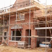 Picture of house being built surrounded by scaffolding