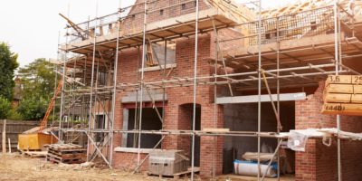Picture of house being built surrounded by scaffolding
