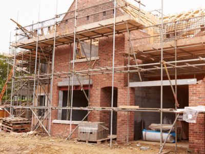 Picture of house being built surrounded by scaffolding
