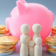 Pink piggy bank with money and figures of people