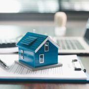 Picture with house, clip board and laptop