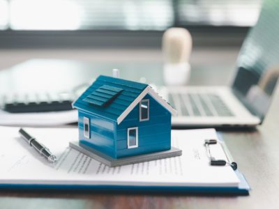 Picture with house, clip board and laptop