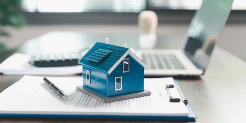 Picture with house, clip board and laptop